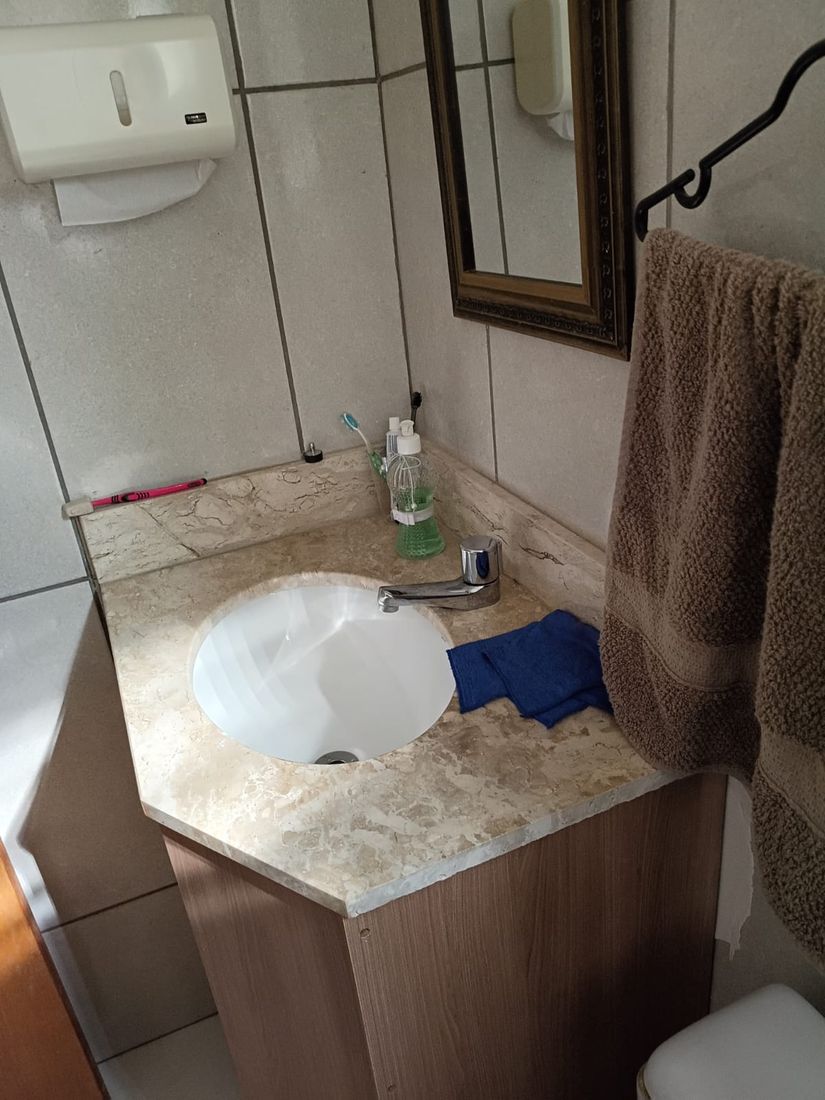 Banheiro com pia de granito e espelho